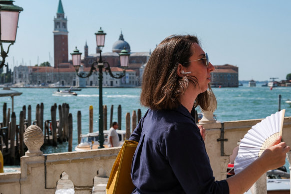 People cool off on a hot day as the city gears up for “Redentore” festival celebrations in Venice, Italy, on July 15.