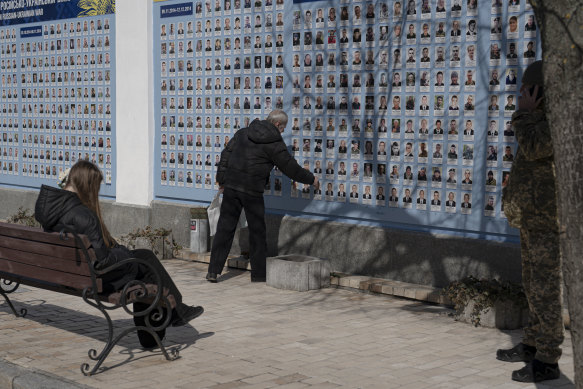 A man stands in front of the Memory Wall of Fallen Defenders of Ukraine in Russian-Ukrainian War on Ukrainian Volunteer Day in Kyiv on Tuesday.