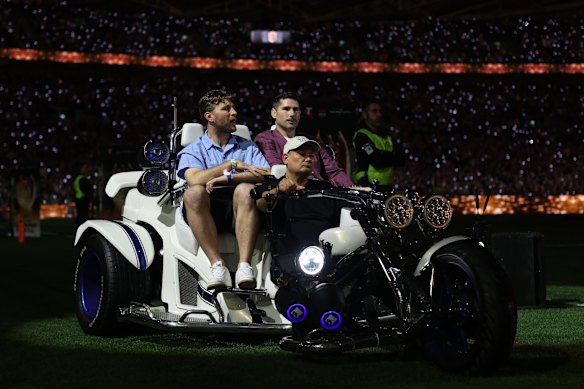Retired South Sydney player Jai Arrow and former Wallaby Nathan Charles take part in a lap of honour.