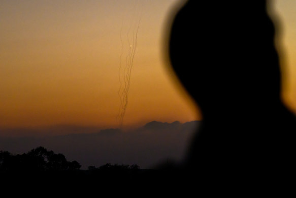 A soldier watches as rockets are fired from Gaza into Israel from Sderot, Israel. 