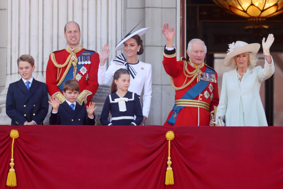 Prince George, Prince William, Prince Louis, Princess Charlotte, Princess Catherine, King Charles and Queen Camilla wave from the Buckingham Palace balcony.