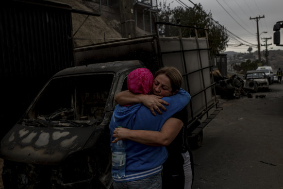 Residents embrace amid the destruction.