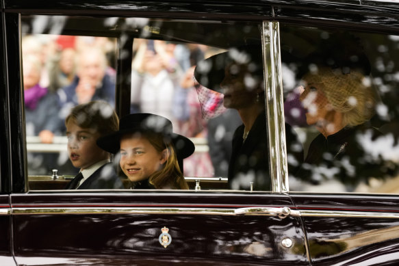 Prince George and Princess Charlotte arrive at Westminster Abbey with Catherine, Princess of Wales (not pictured), and Camilla, Queen Consort.