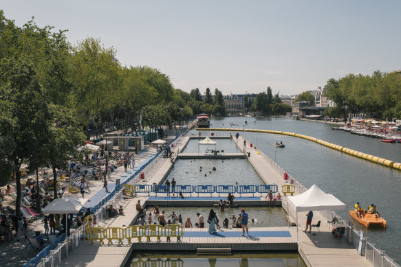 A temporary swimming pool on a canal in Paris. The first swimming pools in the city were built floating atop the Seine.