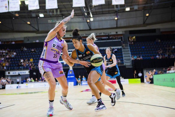 Canberra's Kia Nurse (right) drives past Cayla George of the Melbourne Boomers in Sunday's victory.