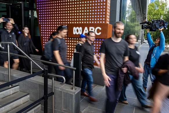 ABC employees walk out of the broadcaster’s Melbourne studios as the strike starts on Wednesday. 