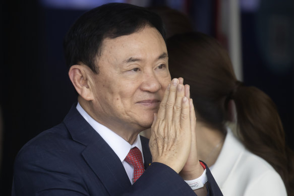 Thaksin Shinawatra greets supporters on his arrival at Don Mueang airport. 