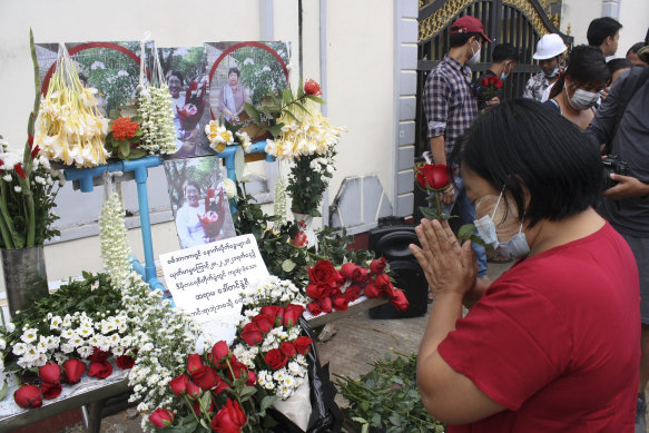 A woman pays tribute to a teacher who killed in Sunday’s protests in Yangon, Myanmar.