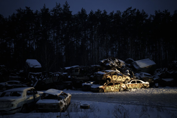 Cars destroyed during Russian attacks, some painted by artists with sunflowers, are stored in the town of Irpin, on the outskirts of Kyiv, Ukraine, on Friday.
