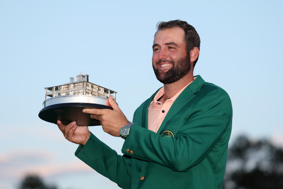 Scottie Scheffler with his green jacket and trophy.