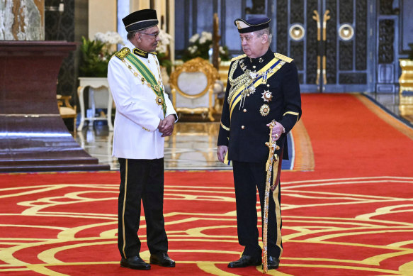 New Malaysian King  Sultan Ibrahim Iskandar, right, speaks with Prime Minister Anwar Ibrahim after the oath taking ceremony at the National Palace in Kuala Lumpur on Wednesday.