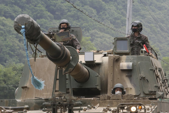 South Korean army soldiers ride a K-9 self-propelled howitzer during the annual exercise in Paju, South Korea, near the border with North Korea, on Tuesday, amid threats from the North. 
