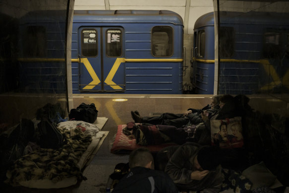 People rest in a subway station being used as a bomb shelter in Kyiv, Ukraine.