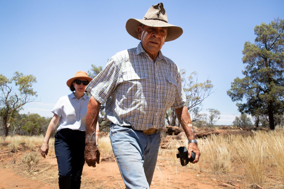 Uncle Peter Harris and NSW Premier Gladys Berejiklian walk through the Mount Grenfell Historic Site. 