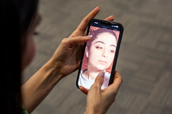A phone displays a photo of Parnia Abbasi, a poet who was one week away from her 24th birthday when she was killed in an Israeli strike last week.