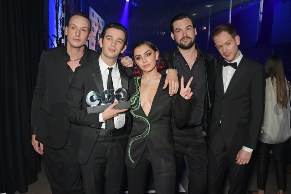 Charli XCX poses with her partner George Daniel, Matthew Healy, Ross MacDonald and Adam Hann of The 1975.