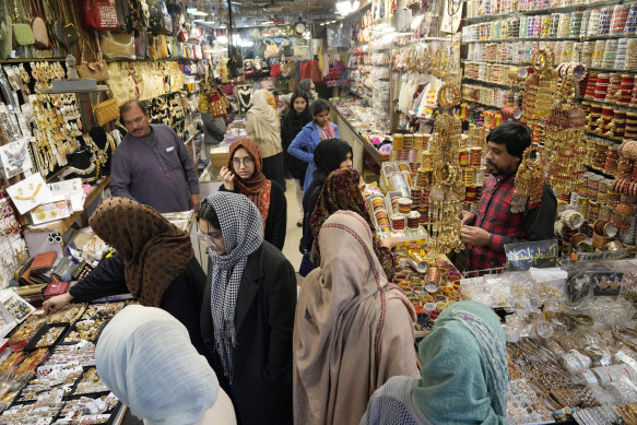 People visit a market in Lahore, Pakistan, where shopping for basic daily needs is largely done at night.