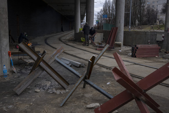 Anti-tank crosses erected near a check-point on the road into Kyiv. Most people left in the city have joined the resistance. 