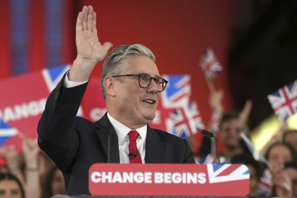 Labour Party leader Keir Starmer waves to party workers and supporters during a post-election rally at the Tate Modern in London.