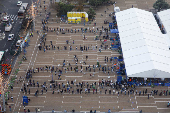 People queue outside a COVID-19 mass vaccination centre at Rabin Square in Tel Aviv.