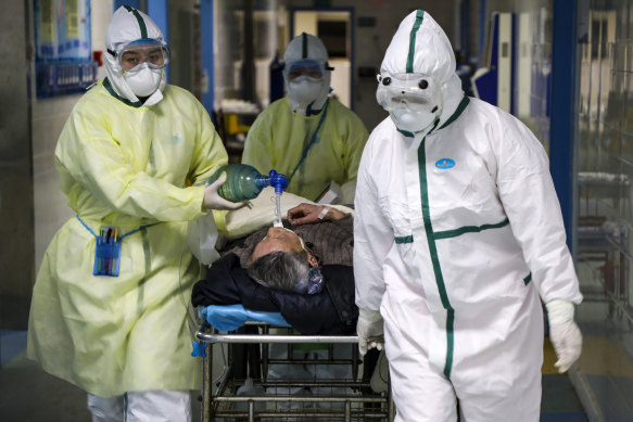 A patient with COVID-19 is treated in a hospital’s isolation ward in Wuhan, China in February 2020. 