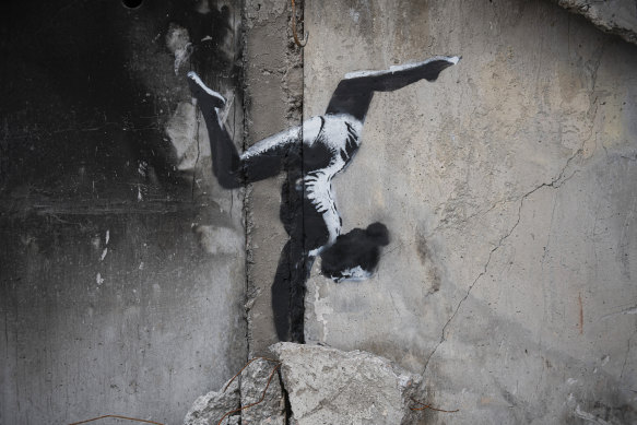 An artwork by British street artist Banksy is seen on a destroyed by fightings building in Borodyanka, Kyiv.