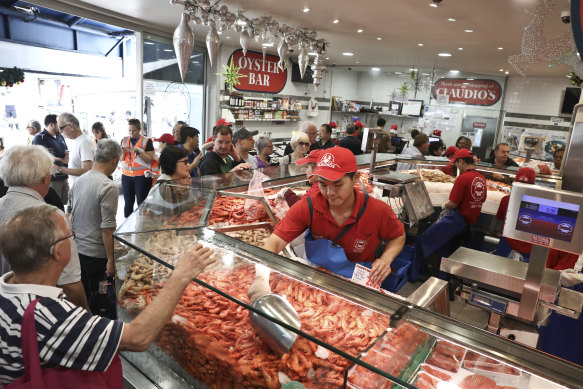 Customers buy prawns at Sydney Fish Market in the lead-up to Christmas.