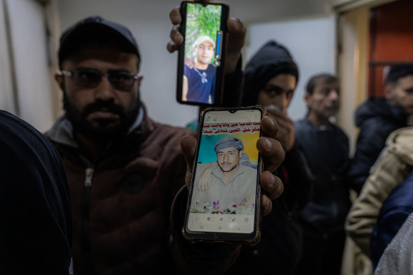 Syrians show photos of missing relatives at al-Moujtahid hospital’s morgue, where bodies of prisoners found at the notorious Sednaya prison were brought.