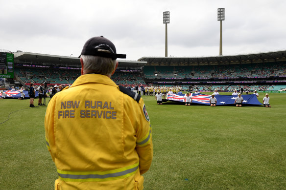 RFS volunteer Deputy Captain John Corry of the Ku-ring-gai Brigade looks on as a minute's applause is observed ahead of the New Year's Test.