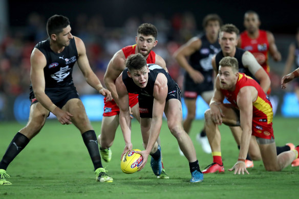 Carlton’s Sam Walsh looks to get the ball away against the Suns on Saturday night.