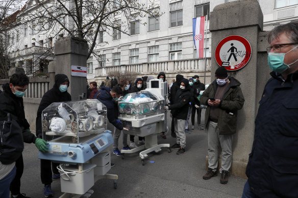 People carry incubators for newborn babies as the hospital is evacuated after the earthquake in Zagreb, Croatia, on Sunday.