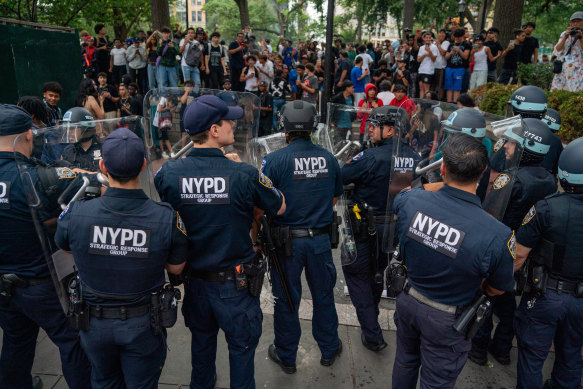 Police officers stand guard as people gather for the “giveaway”.