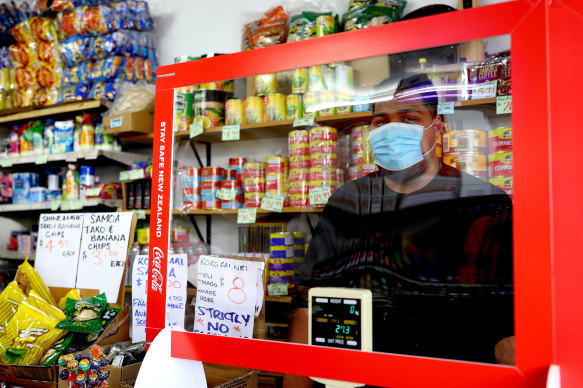 A milk bar owner stands behind his counter in Otara, Auckland, during level-three lockdown.