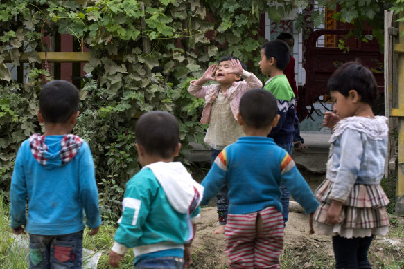 Uighur children play outdoors in Hotan, in western China's Xinjiang region.