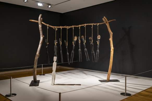 Fiona Foley’s Annihilation of the Blacks, 1986. wood, synthetic polymer paint, feathers, string, 204.5 x 267 x 85.7 cm, 13 parts. National Museum of Australia collection.

