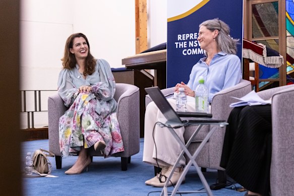 Independent candidate Nicolette Boele (right) and Liberal candidate Gisele Kapterian share a joke at North Shore Synagogue In Lindfield, Sydney, on Tuesday night.