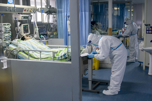 A medical worker attends to a patient in the intensive care unit at Wuhan University’s Zhongnan Hospital in January 2020. 