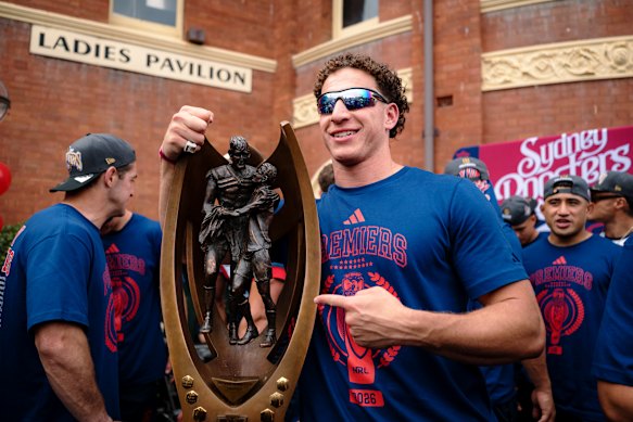 Mark Nawaqanitawase poses for a photograph with the NRL trophy.
