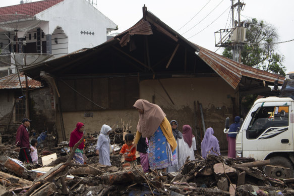 People inspect the damage in Tanah Datar, West Sumatra, Indonesia.
