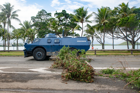 A Gendarmerie armoured vehicle drives past the filtering roadblock set up on the bays, Promenade Pierre Vernier, in Noumea.