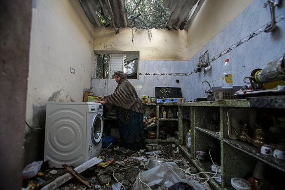 A Palestinian woman inspects her home in the Gaza Strip after Israeli air strikes in May.