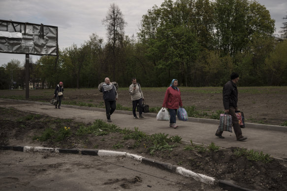 People fleeing the village of Ruska Lozova arrive at a screening point in Kharkiv.