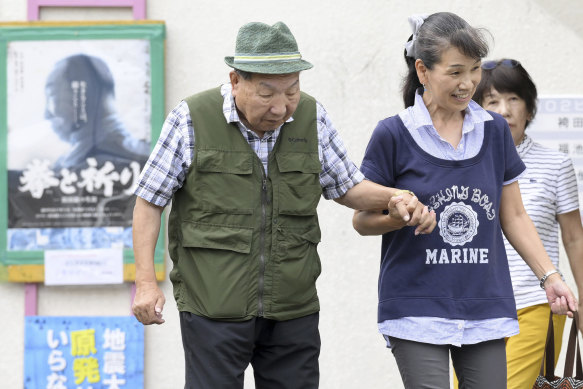 Iwao Hakamada, left, an 88-year-old former boxer who was on death row for nearly five decades, is helped by a supporter as he goes for a walk in Hamamatsu, central Japan.
