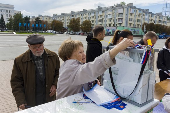 A woman casts her ballot during a referendum in Luhansk, Luhansk People’s Republic controlled by Russia-backed separatists, eastern Ukraine, on Saturday.