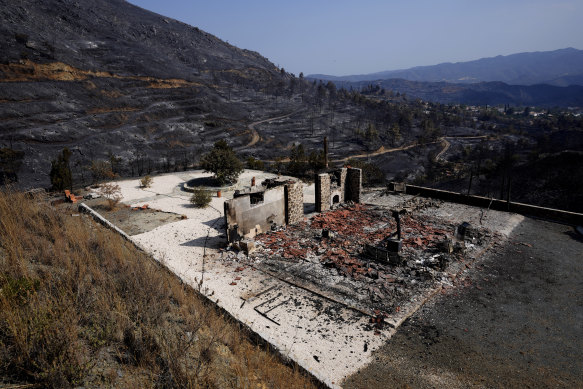 A burnt house is seen on outskirts of Ora village, in the background is the Larnaca mountain region, Cyprus, on Sunday.