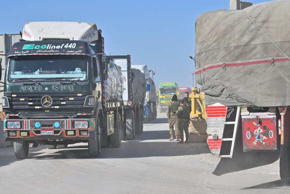 Aid trucks are checked on their way to Gaza at the Kerem Shalom crossing after arriving from Egypt on Friday.