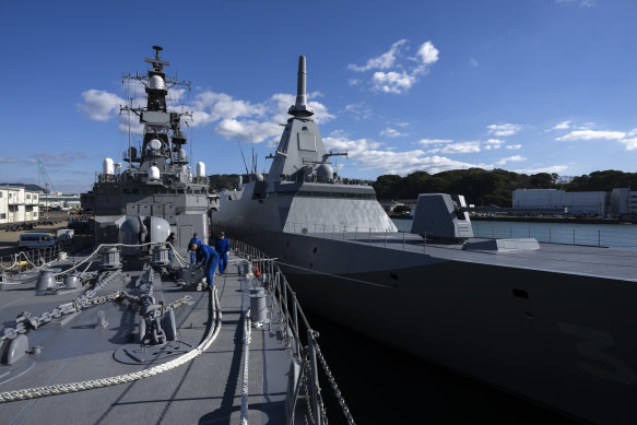 The newly commissioned Noshiro, right, next to an older version of the ship, the Sawagiri, at the Japan Maritime Self-Defense Force headquarters in Sasebo, Japan.