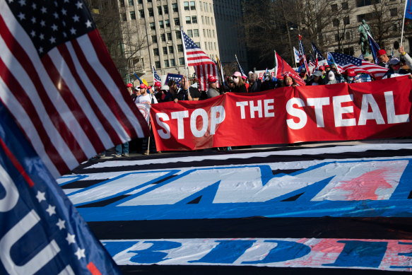 Demonstrators hold a “Stop The Steal” banner in Freedom Plaza during the “Million MAGA March” in Washington, DC weeks before the assault on the Capitol.