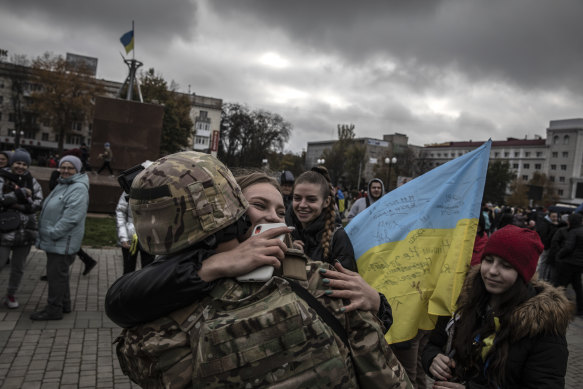 A Ukrainian soldier is hugged at the main square in the recently liberated city of Kherson, Ukraine, on November 13, 2022.