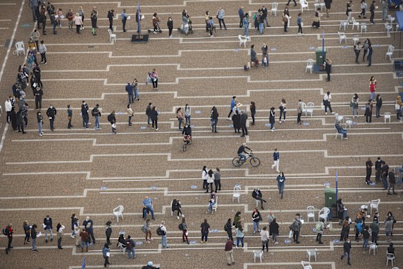 People queue outside a COVID-19 mass vaccination centre at Rabin Square in Tel Aviv, Israel.